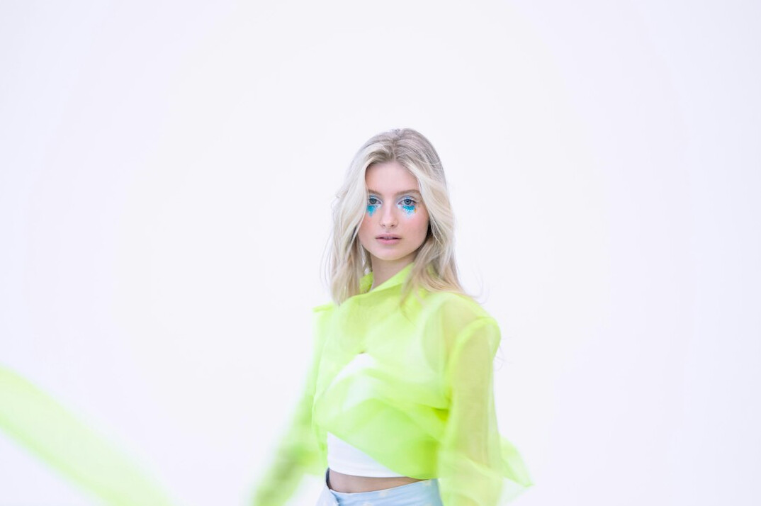 Smiling young blonde woman television presenter in a studio