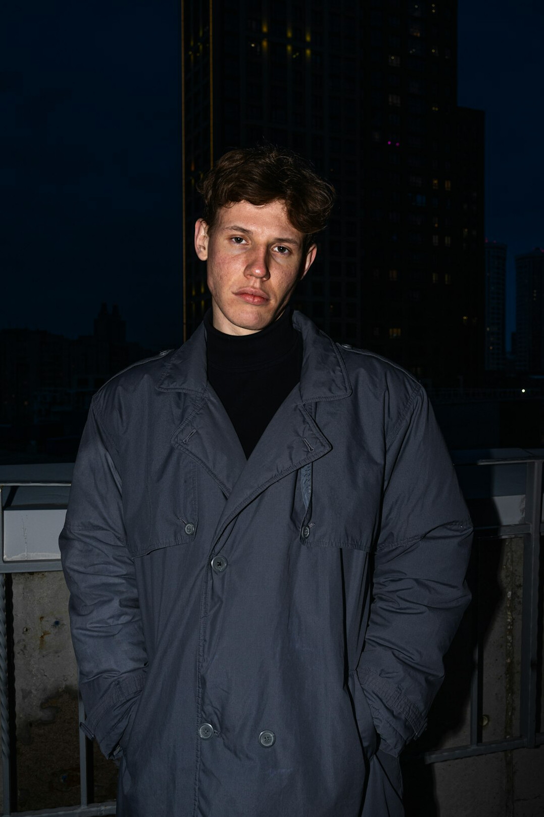 Man in his late thirties with short brown hair wearing a dark jacket
